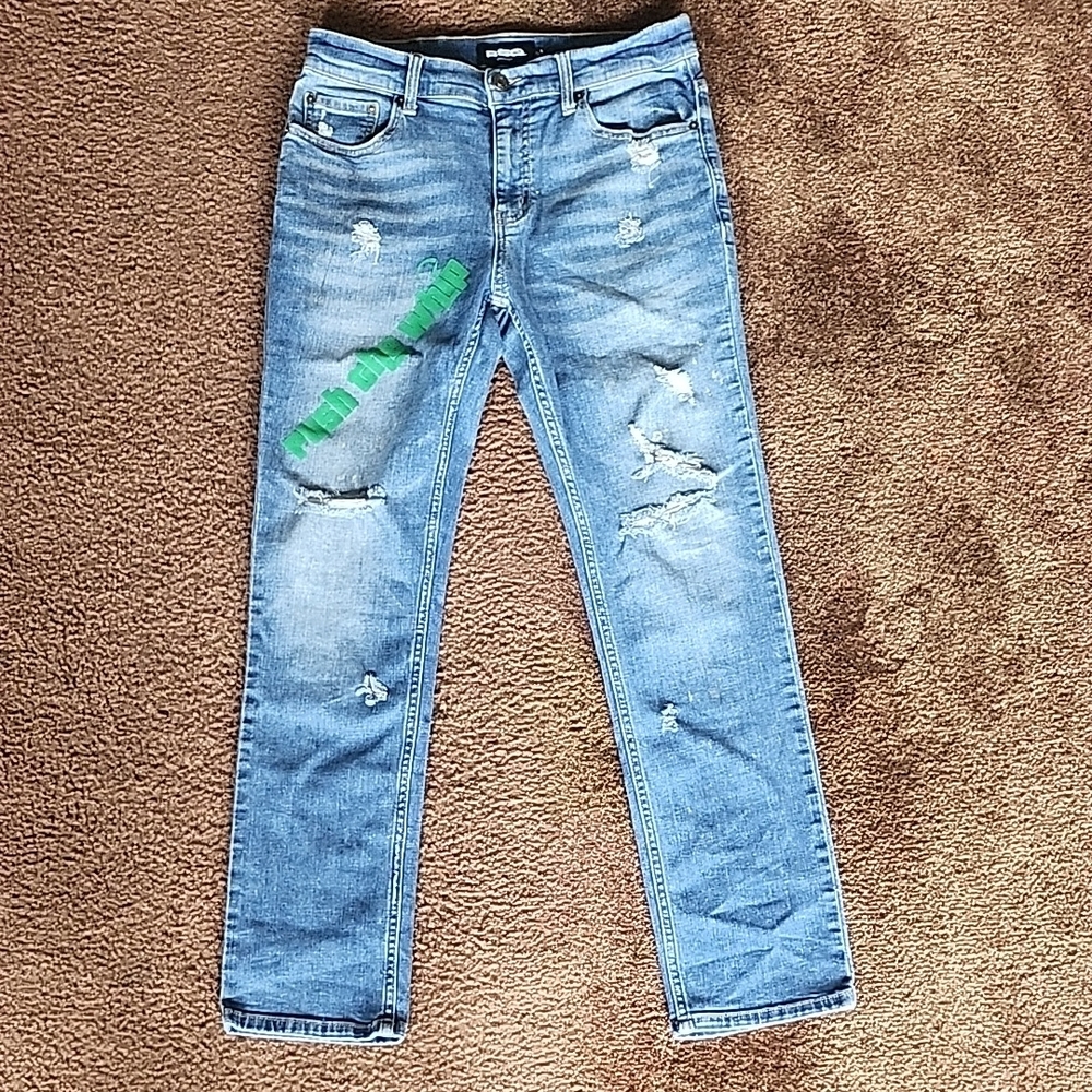 Distressed Blue Jeans with Green Patch
